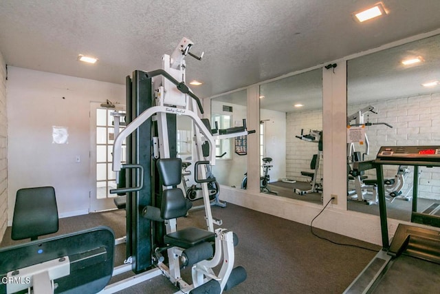workout area featuring a textured ceiling