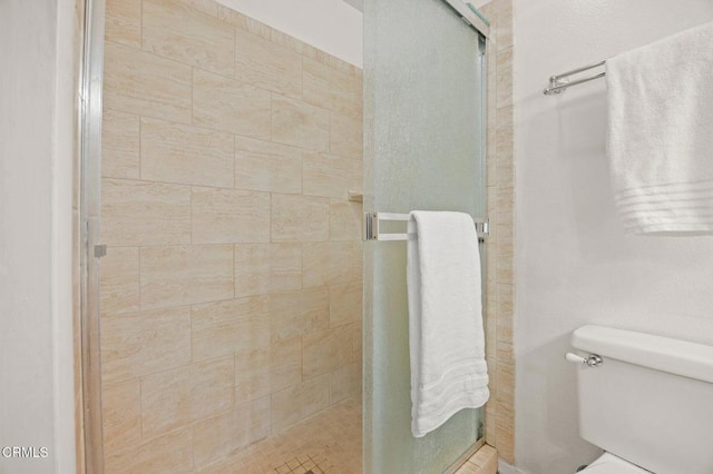full bath with toilet and a stall shower