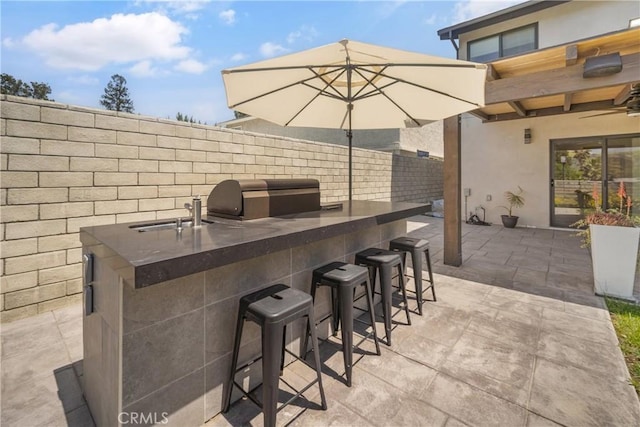 26011 Redbluff Dr, Calabasas, CA 91302 - view of patio featuring an outdoor kitchen, area for grilling, fence, a sink, and outdoor wet bar