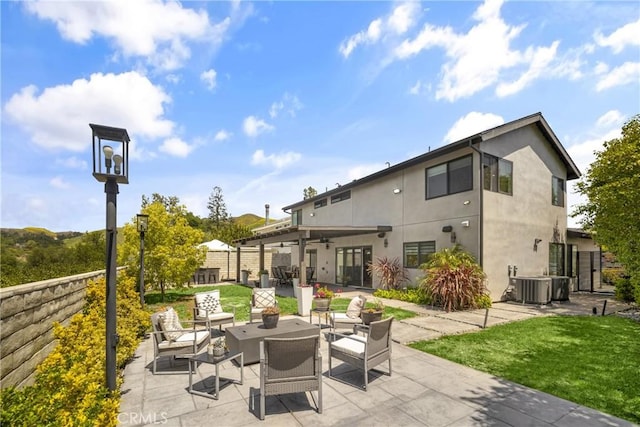 26011 Redbluff Dr, Calabasas, CA 91302 - rear view of house featuring outdoor lounge area, fence, central AC, a patio area, and stucco siding