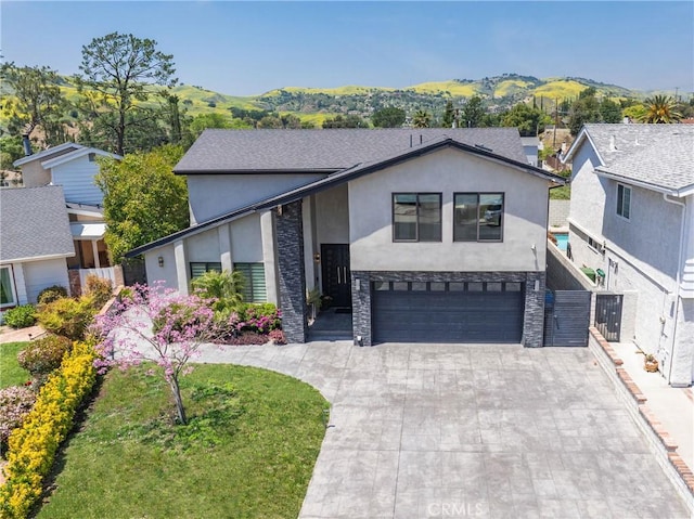 26011 Redbluff Dr, Calabasas, CA 91302 - view of front of home with concrete driveway, stucco siding, a garage, and a mountain view