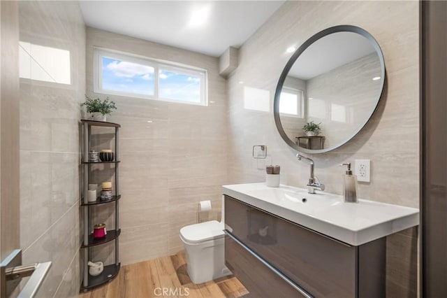 26011 Redbluff Dr, Calabasas, CA 91302 - bathroom with toilet, tile walls, vanity, and wood finished floors