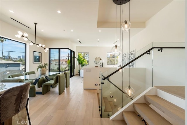 2219 W Starview Ln, Los Angeles, CA 90026 - staircase with recessed lighting, wood finished floors, and a chandelier