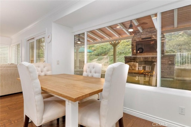 dining area with wood finished floors, a healthy amount of sunlight, and ceiling fan