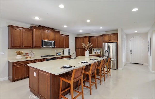 213 Wicker, Irvine, CA 92618 - kitchen with appliances with stainless steel finishes, a sink, recessed lighting, baseboards, and a kitchen bar