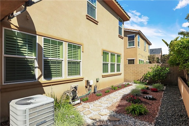 213 Wicker, Irvine, CA 92618 - view of side of property featuring central air condition unit and stucco siding