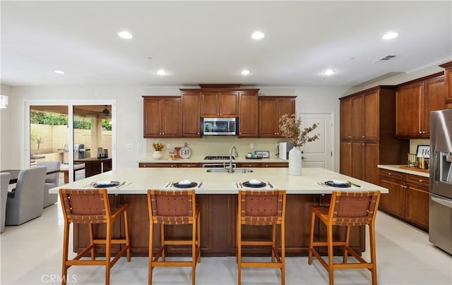 213 Wicker, Irvine, CA 92618 - kitchen featuring appliances with stainless steel finishes, a sink, recessed lighting, light countertops, and a breakfast bar area