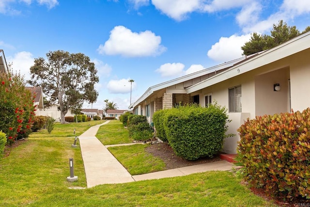 3755 Vista Campana N Unit 58, Oceanside, CA 92057 - view of property exterior with stucco siding and a yard
