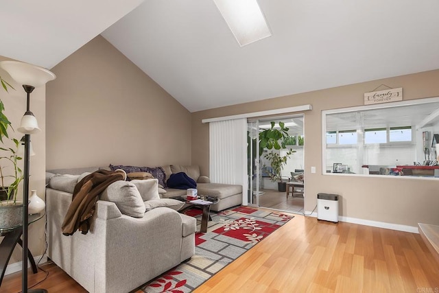 3755 Vista Campana N Unit 58, Oceanside, CA 92057 - living room with vaulted ceiling with skylight and wood finished floors