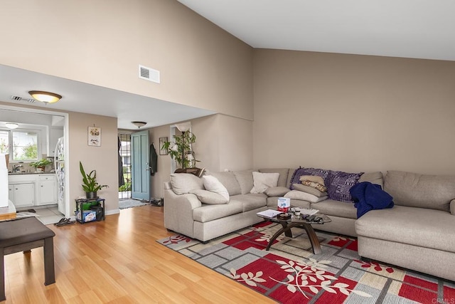 3755 Vista Campana N Unit 58, Oceanside, CA 92057 - living room with light wood-style floors, a high ceiling, and visible vents