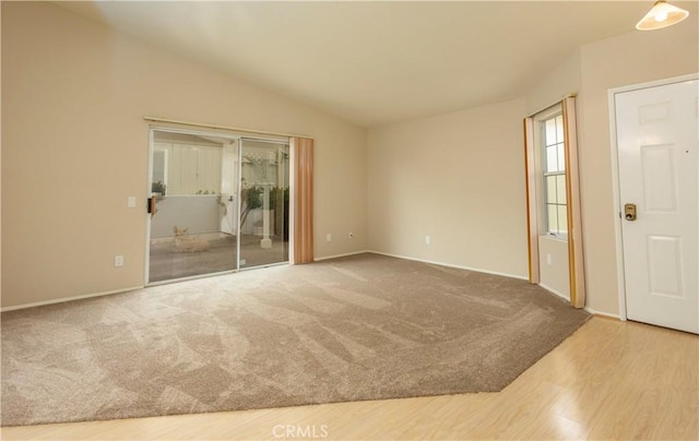 28050 Bavaria Dr, Menifee, CA 92585 - unfurnished room featuring carpet, wood finished floors, baseboards, and lofted ceiling