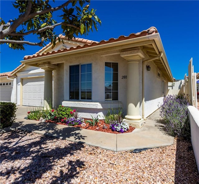 28050 Bavaria Dr, Menifee, CA 92585 - view of front of house with a tiled roof, fence, an attached garage, stucco siding, and concrete driveway
