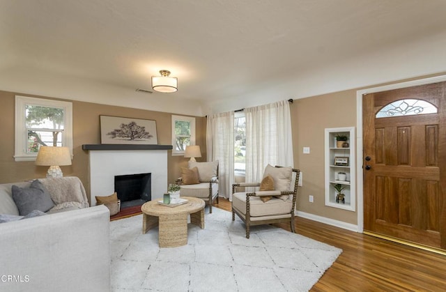3059 Glenrose Ave, Altadena, CA 91001 - living area with plenty of natural light, baseboards, wood finished floors, and a fireplace