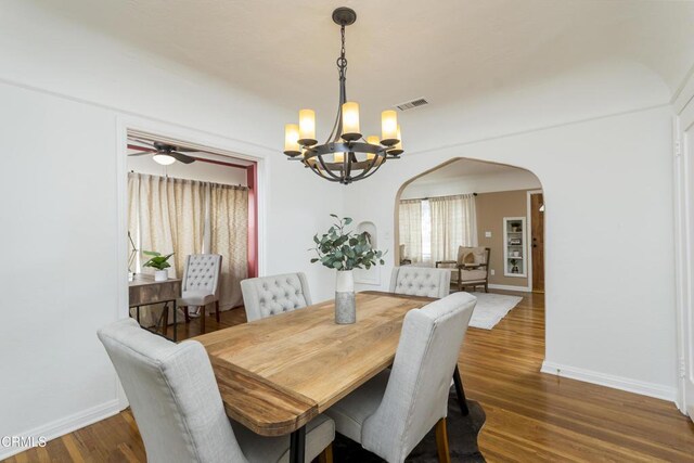 3059 Glenrose Ave, Altadena, CA 91001 - dining area featuring arched walkways, baseboards, visible vents, ceiling fan with notable chandelier, and wood finished floors