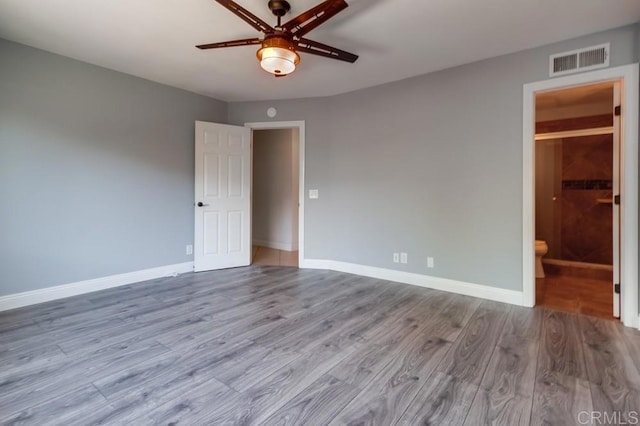 1030 Ball Ave, Escondido, CA 92026 - unfurnished bedroom featuring wood finished floors, baseboards, a ceiling fan, and ensuite bath
