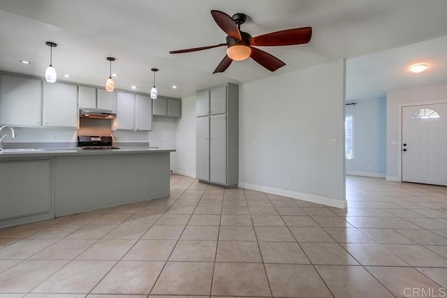 1030 Ball Ave, Escondido, CA 92026 - kitchen with under cabinet range hood, range, ceiling fan, light tile patterned floors, and recessed lighting