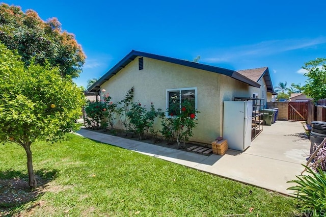 1030 Ball Ave, Escondido, CA 92026 - view of property exterior featuring a gate, stucco siding, and a patio