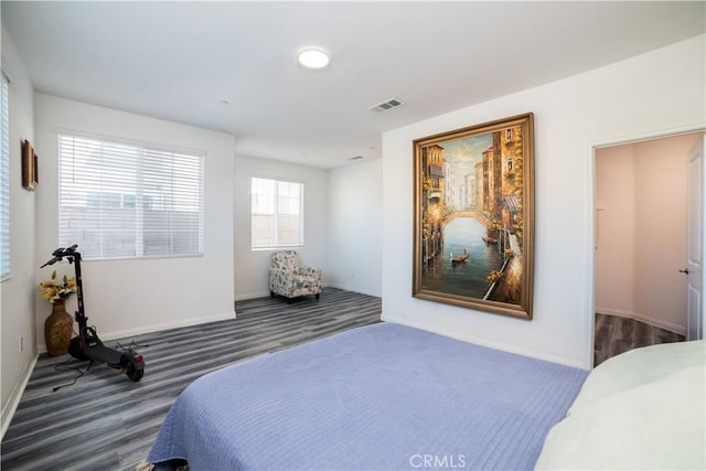 bedroom with dark wood finished floors, baseboards, and visible vents
