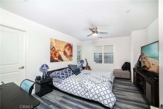 bedroom featuring a ceiling fan and dark wood-style flooring