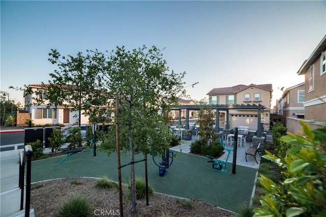 view of play area with fence and a patio area