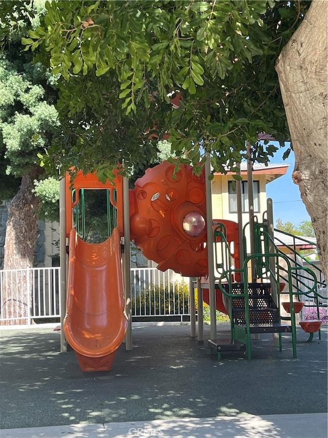 view of jungle gym featuring fence