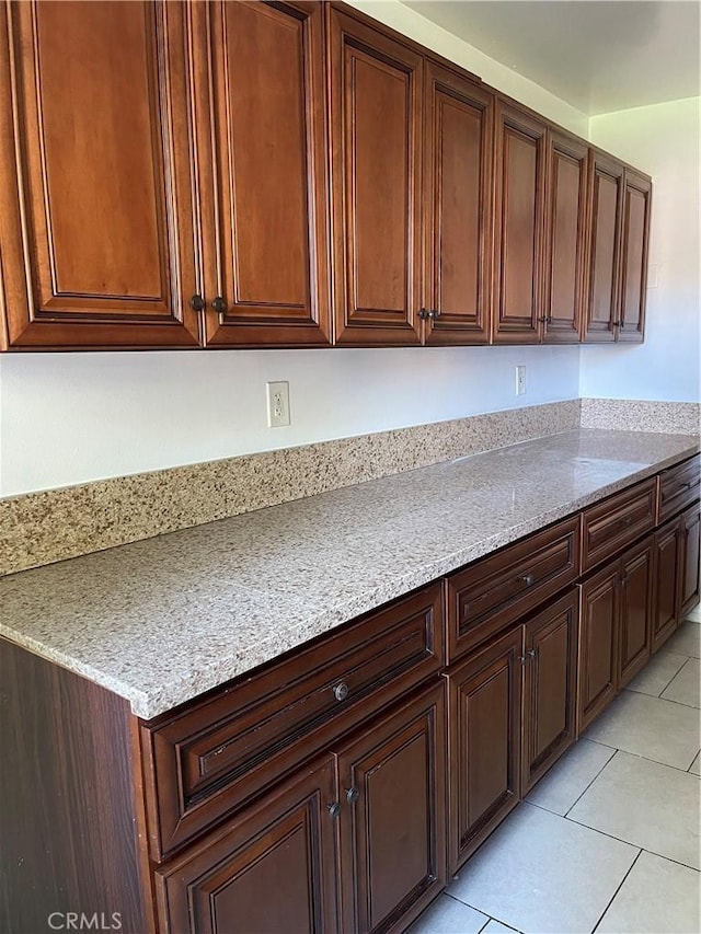 kitchen featuring light stone countertops and light tile patterned floors