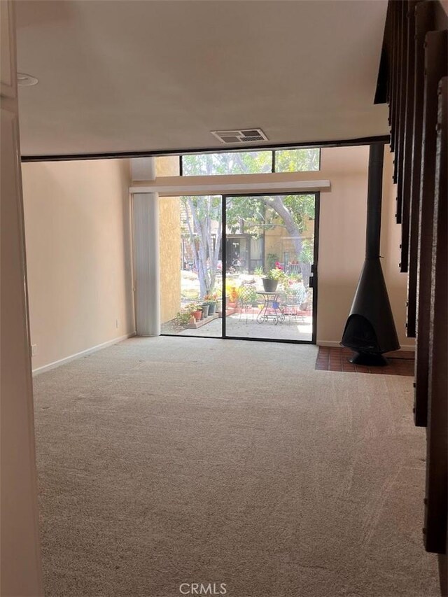 12750 Centralia St Unit 142, Lakewood, CA 90715 - unfurnished room featuring baseboards, floor to ceiling windows, visible vents, and carpet