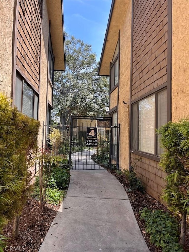 12750 Centralia St Unit 142, Lakewood, CA 90715 - view of side of property featuring a gate and stucco siding
