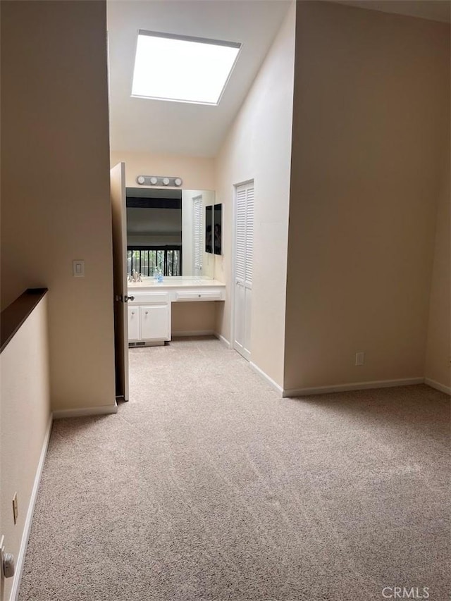 12750 Centralia St Unit 142, Lakewood, CA 90715 - interior space with light colored carpet, baseboards, and lofted ceiling with skylight