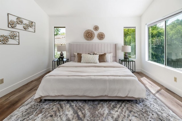 bedroom featuring baseboards and wood finished floors