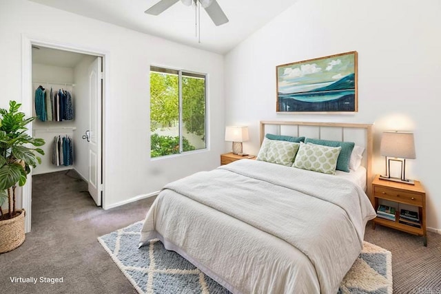 bedroom featuring vaulted ceiling, baseboards, a closet, a spacious closet, and carpet flooring