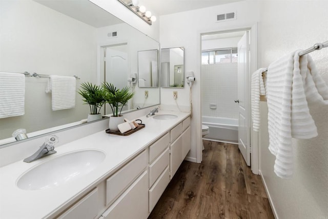 42059 Avenida Vista Ladera, Temecula, CA 92591 - bathroom featuring wood finished floors, double vanity, toilet, and shower / bathtub combination