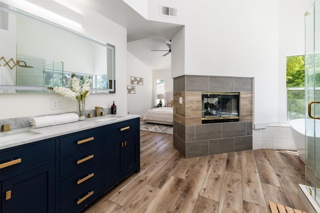 42059 Avenida Vista Ladera, Temecula, CA 92591 - ensuite bathroom featuring high vaulted ceiling, a ceiling fan, wood finished floors, a stall shower, and double vanity
