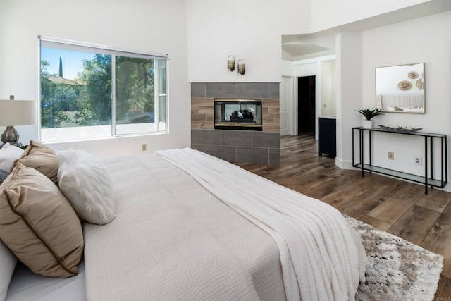 42059 Avenida Vista Ladera, Temecula, CA 92591 - bedroom with dark wood-style floors and a tile fireplace
