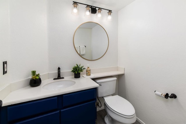 42059 Avenida Vista Ladera, Temecula, CA 92591 - half bathroom with vanity, toilet, baseboards, and wood finished floors
