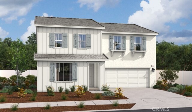 6212 Canal St, Jurupa Valley, CA 92509 - view of front of home with board and batten siding, driveway, a garage, and fence
