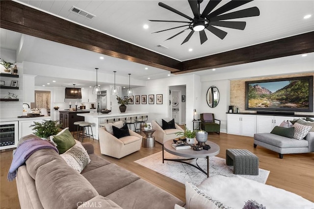 2121 Valhalla Dr, Santa Ana, CA 92705 - living area with wine cooler, beam ceiling, visible vents, light wood-style floors, and a ceiling fan