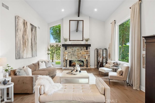2121 Valhalla Dr, Santa Ana, CA 92705 - living room featuring beamed ceiling, plenty of natural light, a stone fireplace, and visible vents