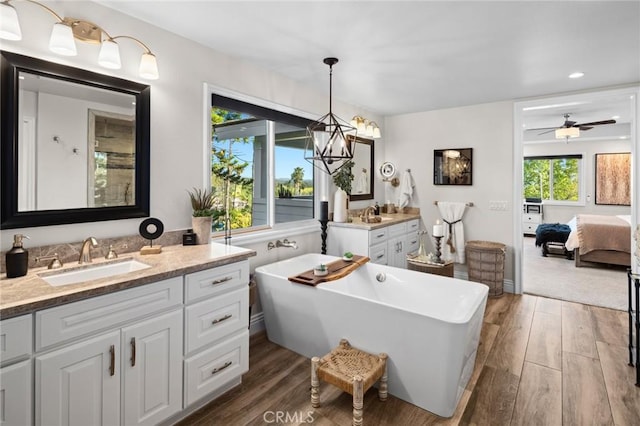 2121 Valhalla Dr, Santa Ana, CA 92705 - ensuite bathroom featuring a freestanding bath, wood finished floors, vanity, and connected bathroom