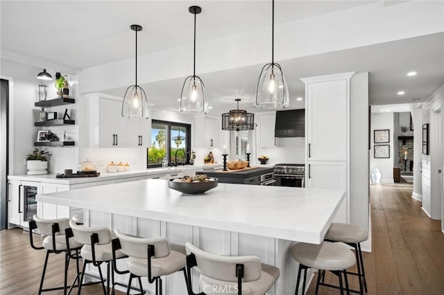 2121 Valhalla Dr, Santa Ana, CA 92705 - kitchen with extractor fan, a kitchen island, high end stainless steel range oven, and decorative backsplash