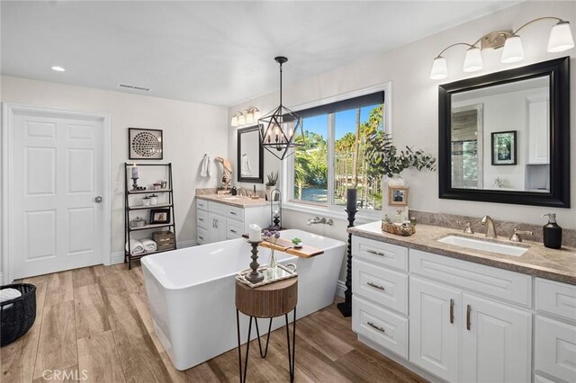2121 Valhalla Dr, Santa Ana, CA 92705 - bathroom featuring wood finished floors, visible vents, and a sink