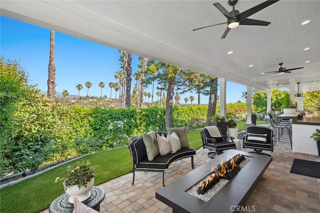 2121 Valhalla Dr, Santa Ana, CA 92705 - view of patio / terrace featuring a bar, an outdoor kitchen, a ceiling fan, and an outdoor living space with a fire pit