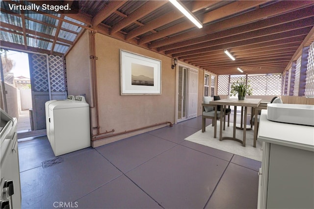 view of patio / terrace with outdoor dining space, washer / clothes dryer, and a pergola