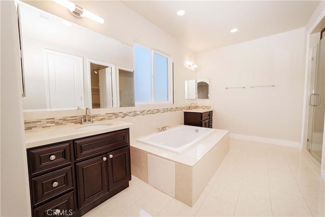 full bathroom with a sink, decorative backsplash, two vanities, a shower stall, and a bath