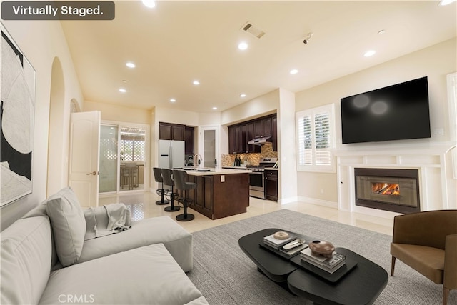 living area featuring visible vents, recessed lighting, and a healthy amount of sunlight