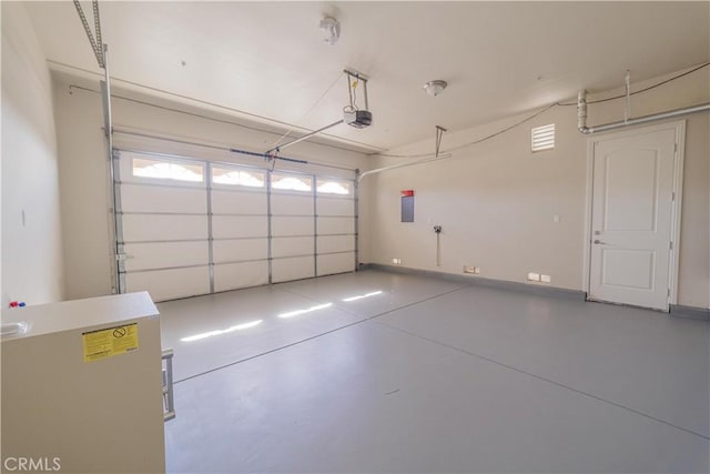 garage with a garage door opener and electric panel