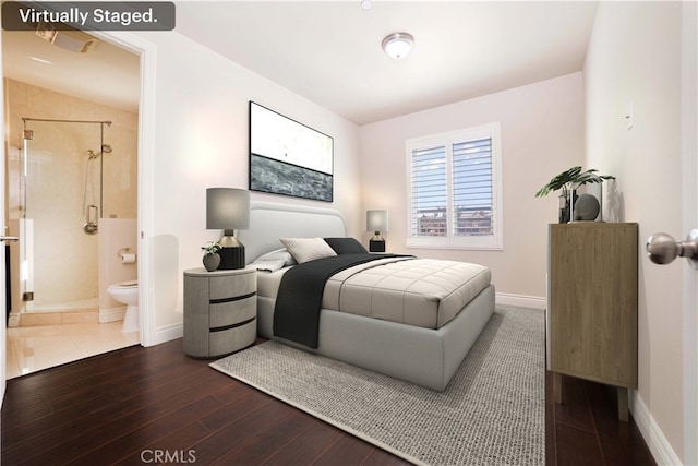 bedroom with baseboards, dark wood-style flooring, and ensuite bathroom