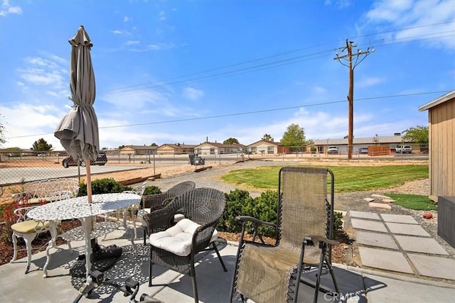 view of patio with a residential view and fence