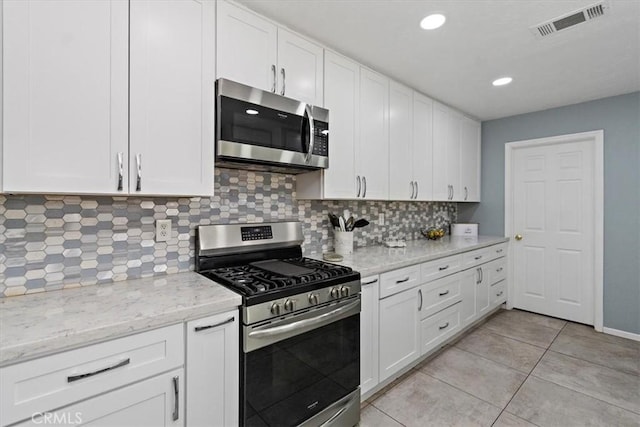 kitchen with white cabinets, visible vents, backsplash, and appliances with stainless steel finishes