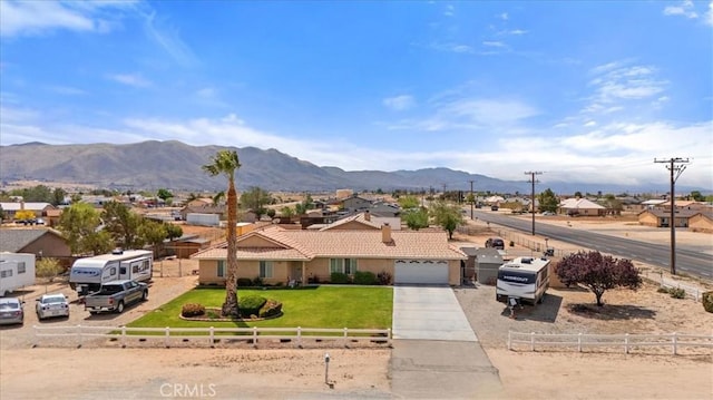 view of front of home featuring a tiled roof, fence private yard, and a mountain view